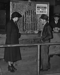 A photograph of someone purchasing food stamps in Los Angeles, California, 1940