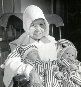 Sister with infants Sisters of Charity of Cincinnati lead a lifetime of service to those in need.