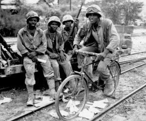 "Negro Marines, attached to the Third Ammunition Company, take time out from supplying ammunition to the front line on Saipan.