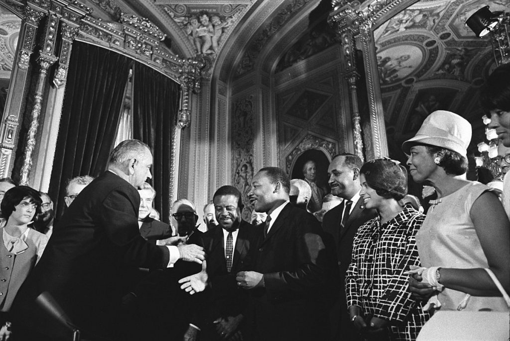 President Lyndon B. Johnson, Martin Luther Kind, Jr. and Rosa Parks at the signing of the Voting Rights Act on August 6, 1965
