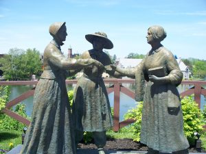 Life sized statues of Amelia Bloomer, Susan B. Anthony, and Elizabeth Cady Stanton. Posed as if it were a scene taking place before us.