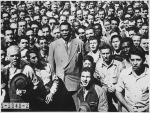 Paul Robeson, world famous baritone, leading Moore Shipyard workers in singing the Star Spangled Banner, 1942